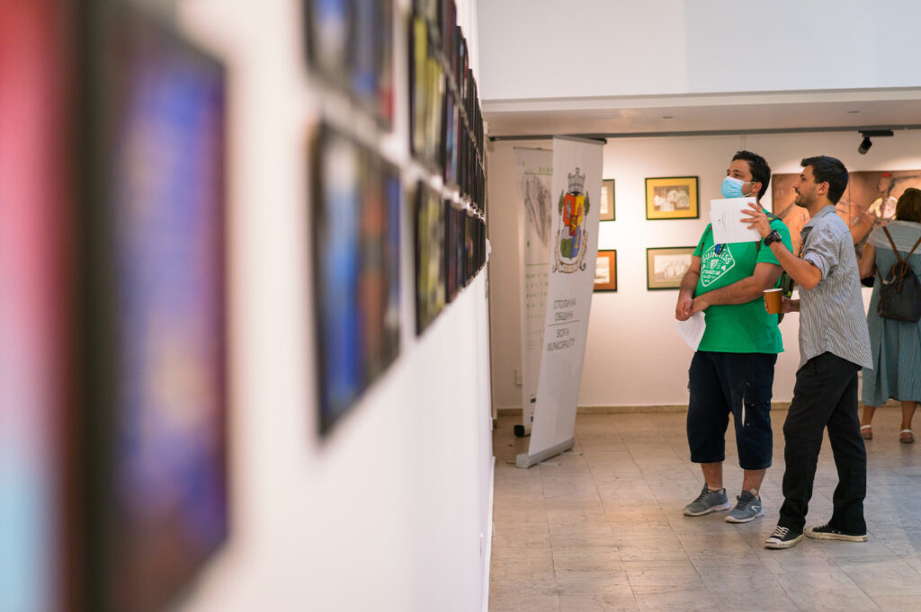 close-up-of-visitors-engaging-with-mixed-media-cardboard-works